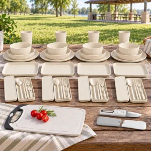 Cream 46-piece wheat straw dinnerware set and meal-prep accessories arranged at an open family park picnic table