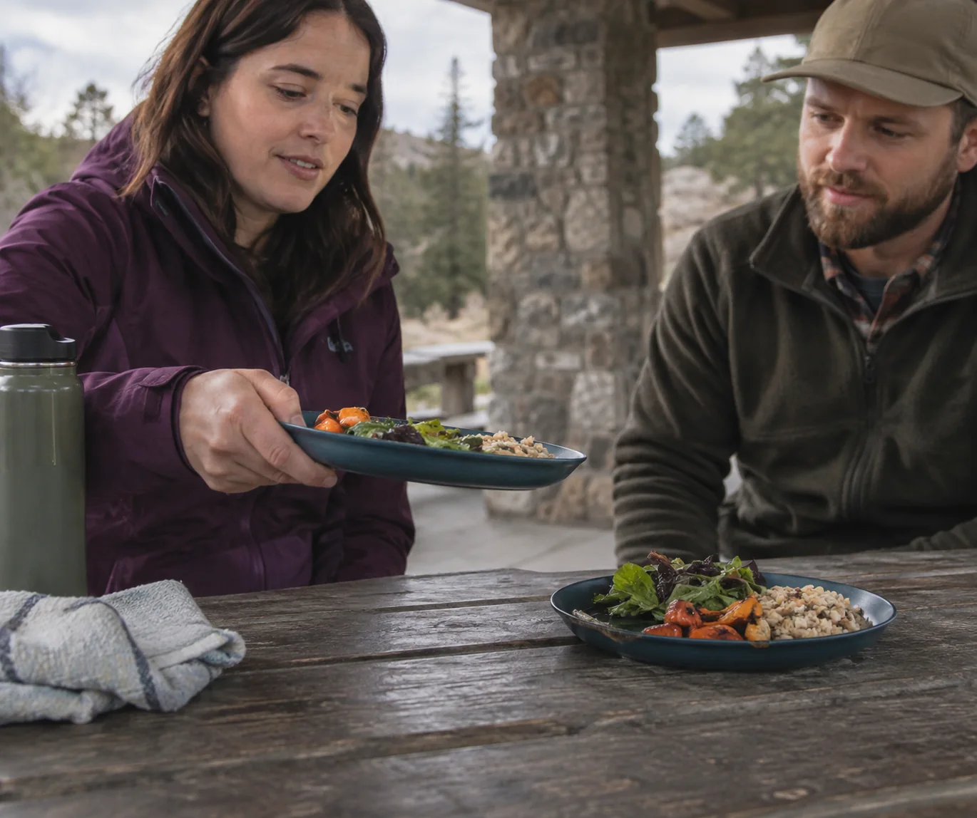 Buyer lifting a camping plate by its rim during a picnic shelter handling review
